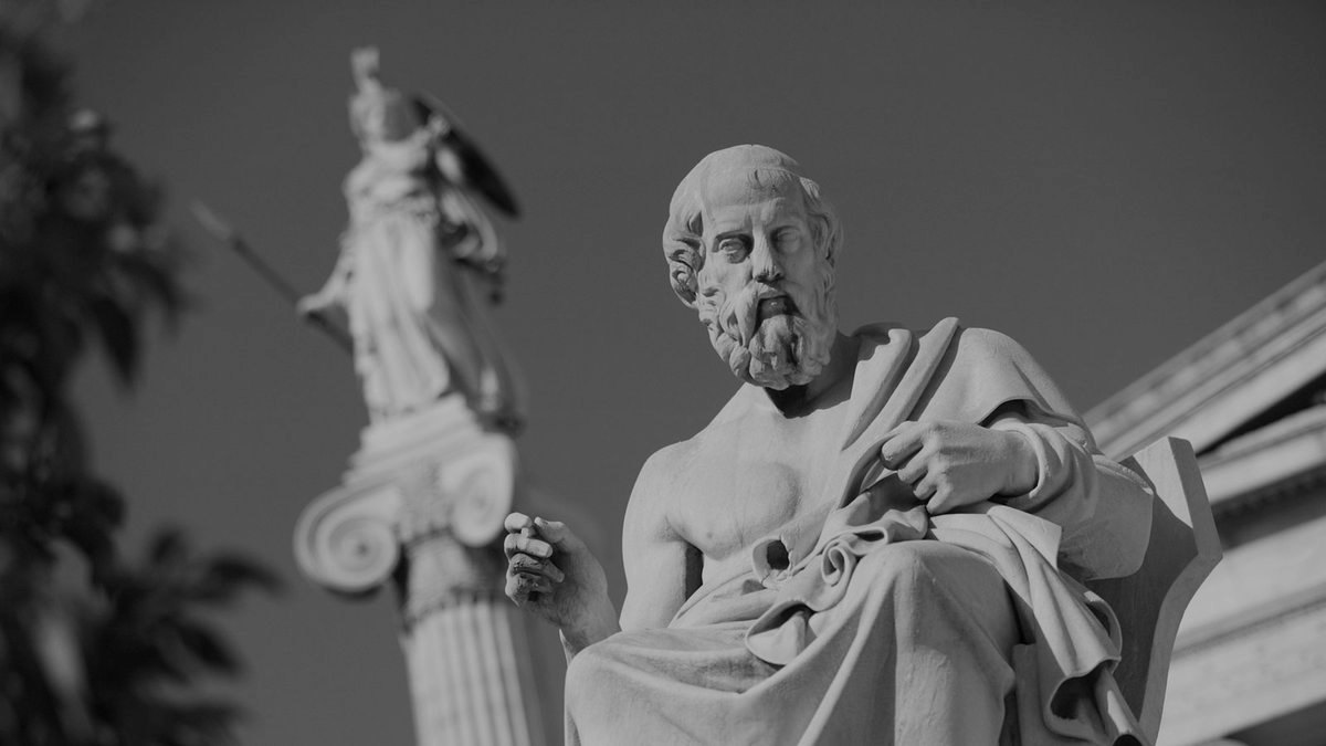 Marble statue of Plato seated, with the Academy of Athens behind